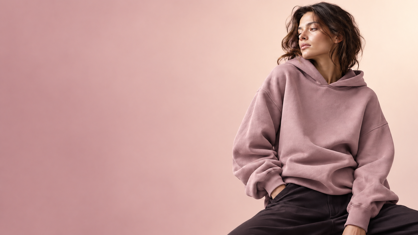Thoughtful woman wearing a deep plum oversized hoodie